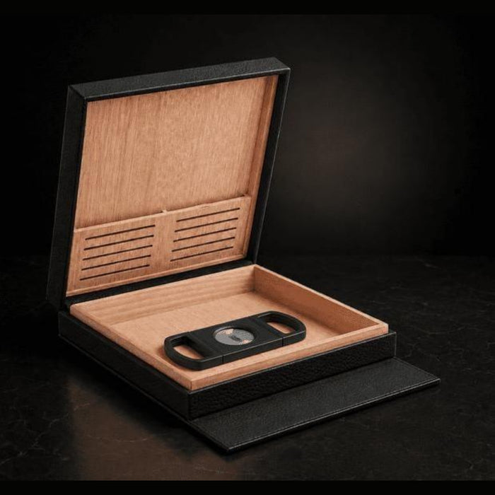 S.T. Dupont holiday set SET-CR-02 - open black leather travel humidor with cedar interior holding a black guillotine cigar cutter